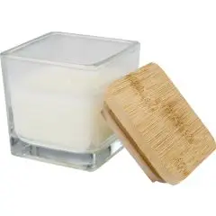 Bougie parfumée personnalisée Ambra en verre carré à cire blanche, couvercle en bambou posé contre le pot